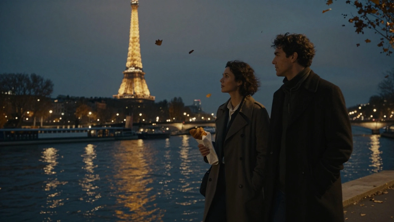 Two figures walk peacefully along the Seine at night, Eiffel Tower glowing in the distance.