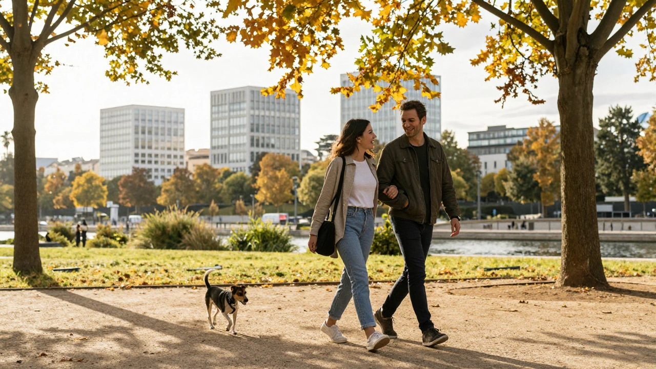 A woman and man walking together in Parc de Bercy, laughing under autumn trees near the canal.